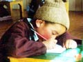 Child writing intensely.