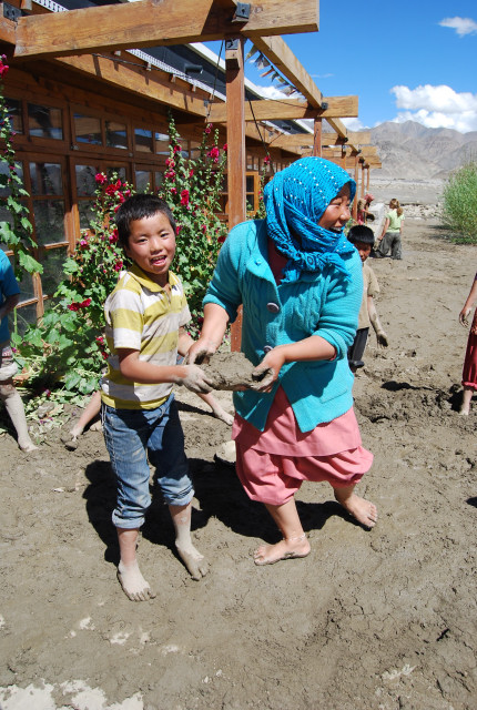 Child clearing a classroom...|<b>... with one of the house mothers</b>