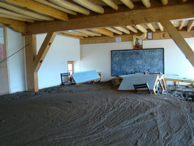 A junior classroom flooded with mud|<b>A junior classroom before HCC started to clear the mud</b>