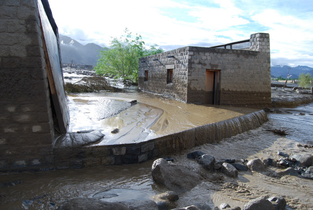 Mud and water overflows...|<b>above the stone wall between 2 latrines</b>