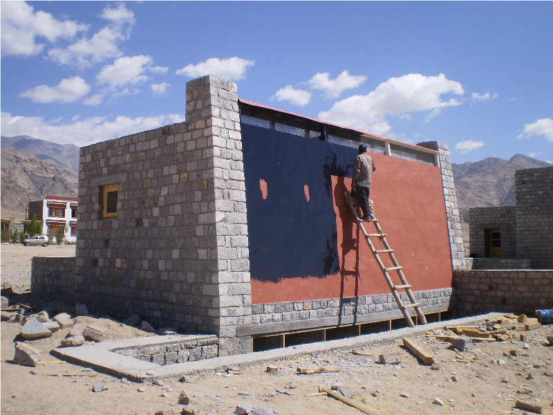 VIP latrine under construction with metal cladding being painted black to absorb heat and cause fumes to rise|VIP latrine under construction with metal cladding being painted black to absorb heat and cause fumes to rise